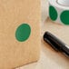 A brown box with a Lavex green circle label and black pen.