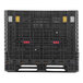 A black Orbis BulkPak container on a black plastic pallet with yellow and red parts.