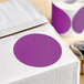 A box with a roll of Lavex purple round inventory labels with a purple circle sticker on it.