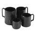 A close-up of a Tablecraft black stainless steel frothing pitcher with a handle.