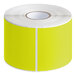 A roll of chartreuse rectangular labels with white edges.