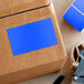 A cardboard box with a blue rectangular Lavex label on it.