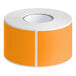 A roll of Lavex fluorescent orange rectangular inventory labels with white peel and stick backing.
