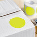 A roll of white Lavex chartreuse inventory labels with yellow circles.