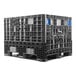 A black Orbis collapsible plastic container on a grey plastic pallet.