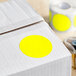 A white box with a yellow circle sticker on it.