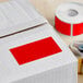 A white box with a red rectangular label on it.