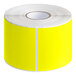 A roll of bright yellow rectangular Lavex inventory labels with white edges.