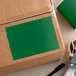 A green rectangular Lavex inventory label on a cardboard box.