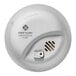 A First Alert hardwired carbon monoxide alarm with a white button.