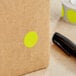 A brown box with a Lavex Chartreuse round inventory label with a yellow dot on it.