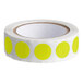 A roll of chartreuse round inventory labels with yellow dots on a white background.