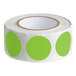 A roll of green circle stickers with white backing.