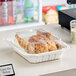 A tray of chicken in a Pactiv white plastic container.