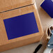 A cardboard box with a Lavex dark blue rectangular label on it.