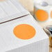 A white box with a roll of Lavex fluorescent orange inventory labels with orange semi-gloss paper.