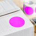 A white roll of Lavex fluorescent pink paper labels with pink dots.