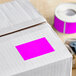 A Lavex fluorescent pink rectangular inventory label on a roll.