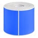 A roll of light blue rectangular labels with white paper on the roll.