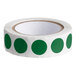 A roll of green round paper labels with a white background.