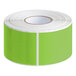 A roll of Lavex fluorescent green rectangular inventory labels with white text on white paper.