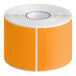 A roll of Lavex fluorescent orange rectangular inventory labels with white backing.