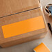 A box with a yellow Lavex rectangular inventory label on it.