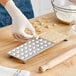 A person using the Imperia RavioChef ravioli mold to make ravioli.