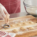 A person using an Imperia circle stamp to make ravioli.