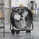 A large black Boltic portable industrial drum fan on wheels.