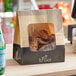 A brown and black Bagcraft EcoCraft meal bag with chicken wings in it.