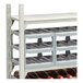 A soft gray Cambro Camshelving triple stack wine cradle with bottles of wine on it.