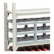 A soft gray Camshelving single stack wine cradle with wine bottles on it.