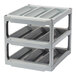 A stack of gray plastic Camshelving wine cradles.