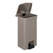 A beige Suncast step-on trash can with a metallic lid.