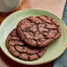 Two Red Plate Foods Individually Wrapped Double Chocolate Cookies on a plate.