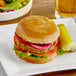 A Katz Gluten-Free burger on a plate with a pickle.