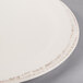 A close up of a white Libbey porcelain plate with a brown rim.