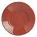 A close-up of a Libbey Farmhouse red porcelain bowl with a black rim.