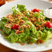 A salad with cherry tomatoes and Clown Toasted Onion Bits.