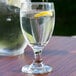 A close-up of a Libbey Banquet Goblet filled with water and a lemon slice.