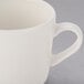 A close-up of a Libbey Farmhouse white porcelain cup with a handle.