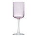 A close-up of a Libbey pink wine glass with a stem.