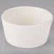 A Libbey Farmhouse white porcelain bouillon bowl with a rim on a gray surface.