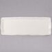 A white rectangular porcelain tray with a small handle.