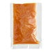 A plastic bag of orange liquid with a white label reading "Clown Single-Serve Caramel Icing"