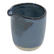 A blue and white ceramic Front of the House Artefact creamer pitcher with a handle.