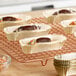 A tray of gold oval baking cups holding chocolate covered treats.
