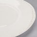 A close up of a Libbey Farmhouse round white porcelain plate with a wide rim.