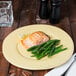 A Libbey Farmhouse butter yellow porcelain plate with salmon and green beans on a table.